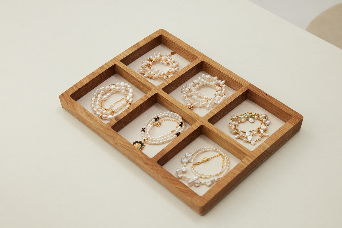 A curated tray of Kairos bracelets displayed for comparison