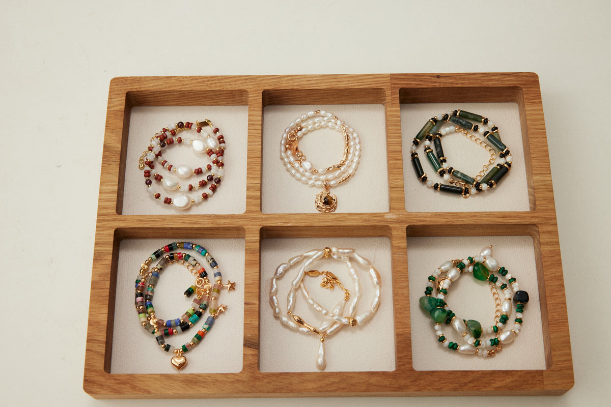 Kairos natural-stone and pearl bracelets arranged by material and color