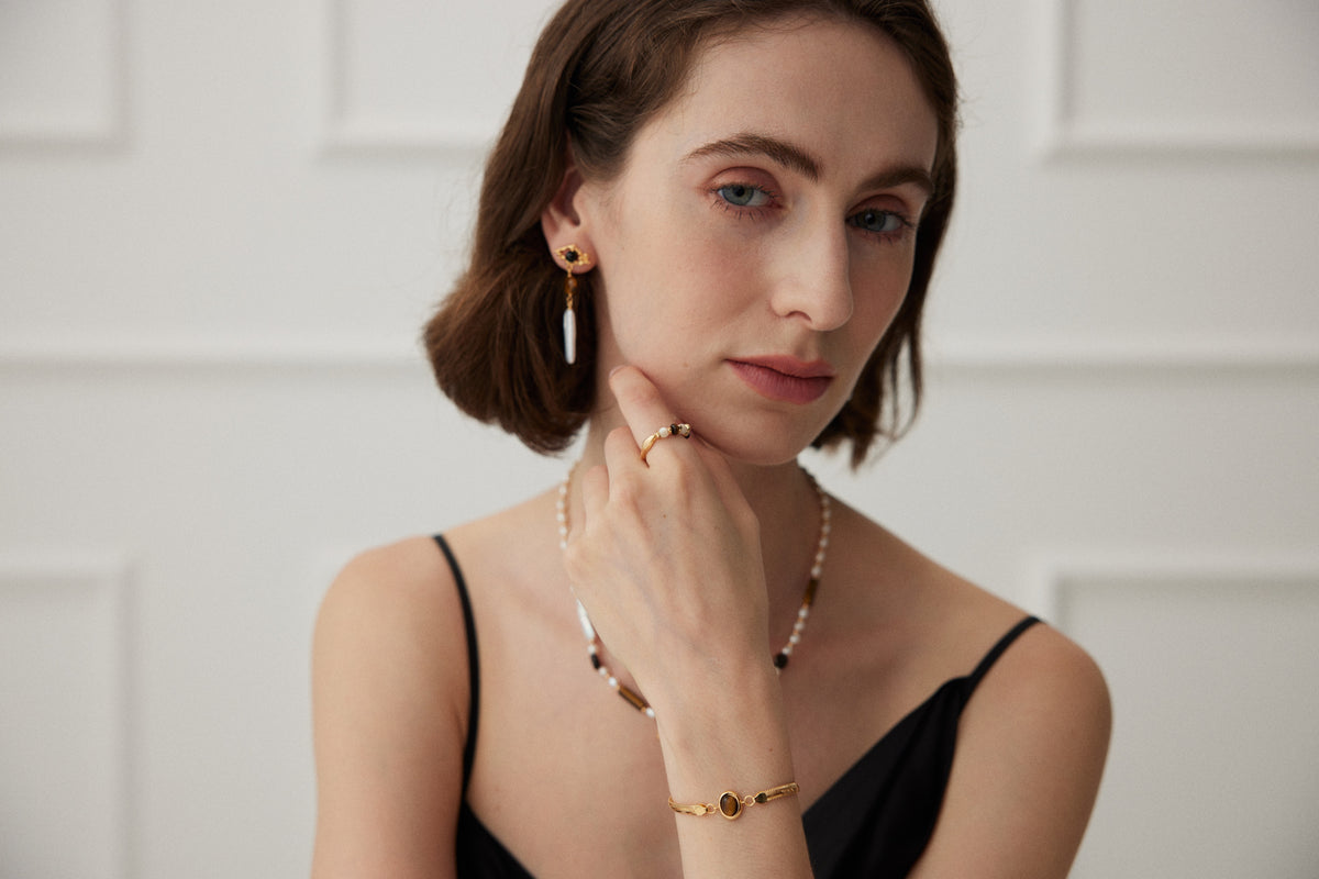 Kairos model styling layered necklaces and earrings
